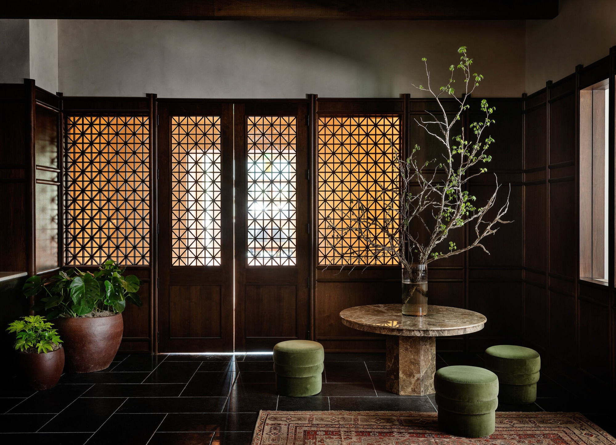 The Forth lobby with a backlit screen, marble table, and velvet seating
